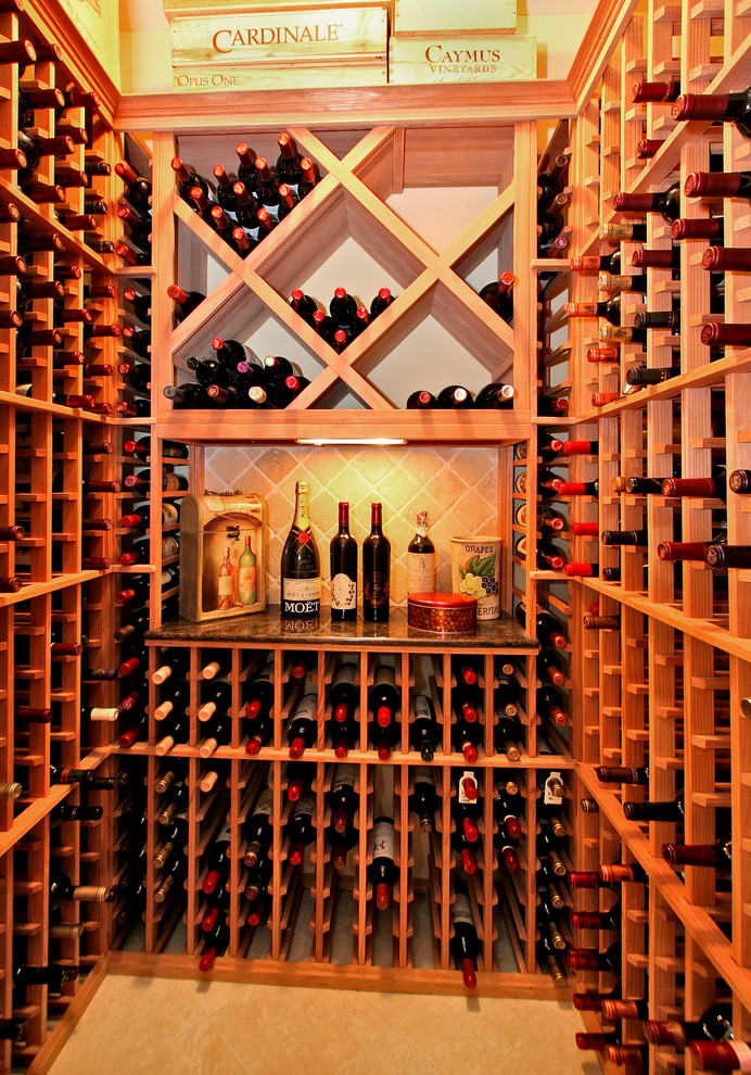 This is an example of a small traditional wine cellar in San Diego with marble floors and storage racks.