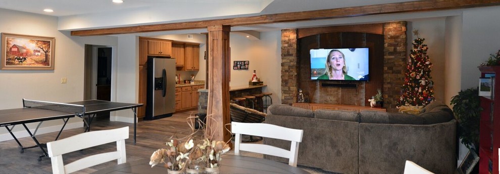 Example of a large transitional walk-out medium tone wood floor basement design with beige walls