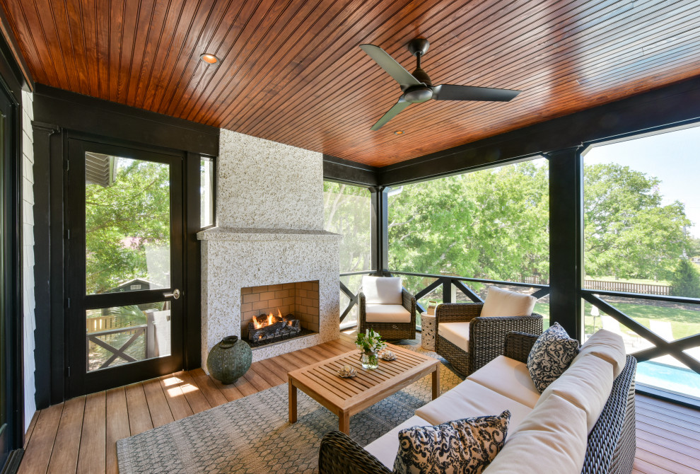 Beach style backyard verandah in Charleston with with fireplace and a roof extension.