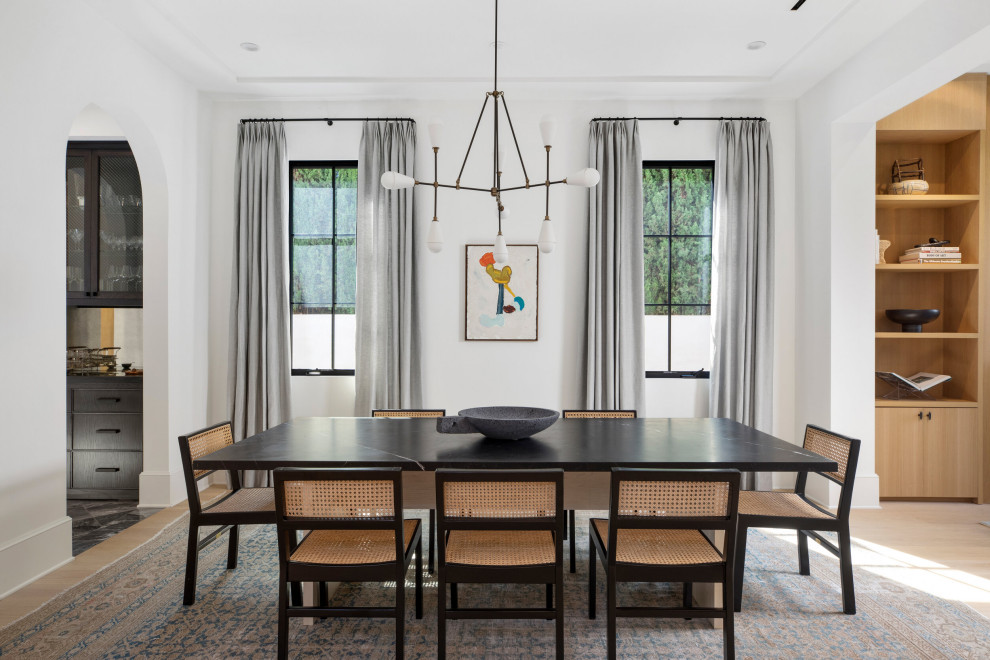 Inspiration for a large transitional separate dining room in Los Angeles with white walls, light hardwood floors, no fireplace, beige floor and recessed.