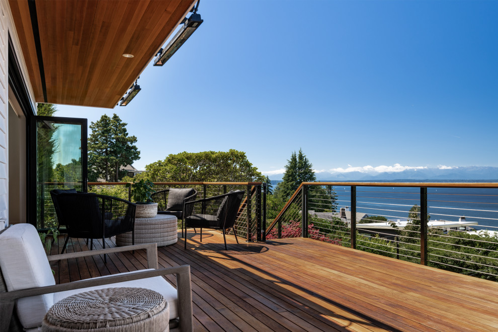 Large traditional back first floor mixed railing terrace in Seattle with a roof extension.