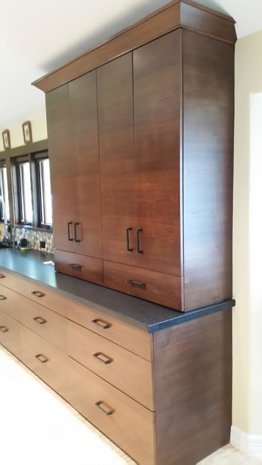 Inspiration for a mid-sized transitional light wood floor and beige floor open concept kitchen remodel in Houston with flat-panel cabinets, medium tone wood cabinets, solid surface countertops, multicolored backsplash, glass tile backsplash, stainless steel appliances and no island