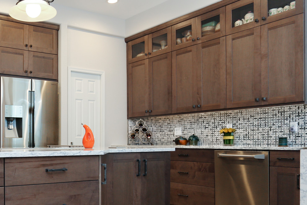 Kitchen - porcelain tile kitchen idea in Phoenix with an undermount sink, shaker cabinets, gray cabinets, quartz countertops, white backsplash, ceramic backsplash, stainless steel appliances and an island