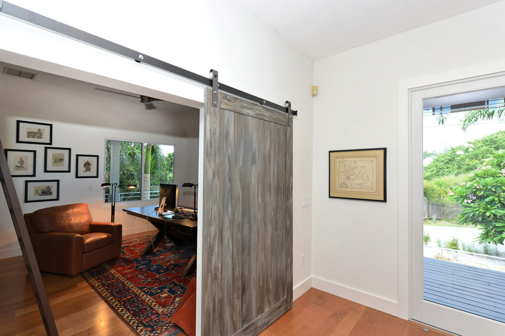 Transitional freestanding desk light wood floor home office photo in Tampa with white walls and no fireplace