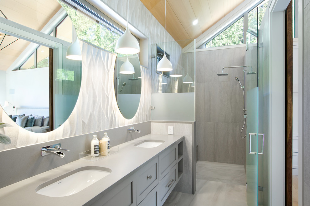 Photo of a transitional bathroom in Vancouver with shaker cabinets, grey cabinets, a corner shower, an undermount sink, grey floor, a hinged shower door and grey benchtops.