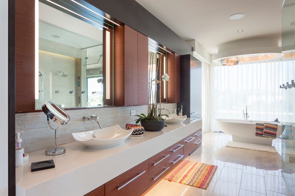 Large contemporary master bathroom in Other with flat-panel cabinets, dark wood cabinets, a freestanding tub, a curbless shower, beige tile, matchstick tile, white walls, light hardwood floors, a vessel sink, solid surface benchtops, a hinged shower door and beige floor.