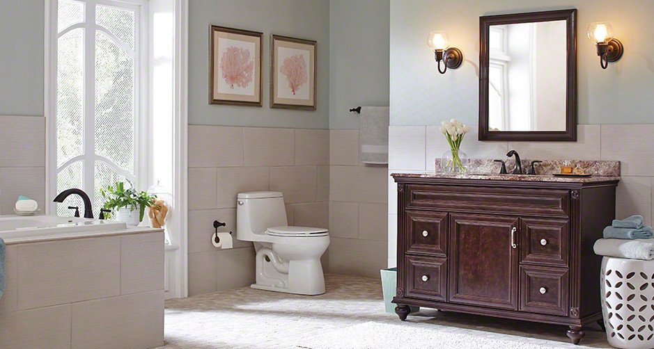 Design ideas for a mid-sized traditional master bathroom in Orlando with recessed-panel cabinets, dark wood cabinets, a drop-in tub, a one-piece toilet, beige tile, porcelain tile, blue walls, mosaic tile floors, an undermount sink, granite benchtops and beige floor.