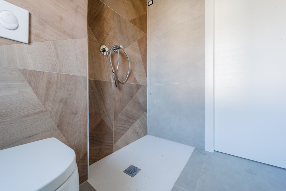 Small contemporary cloakroom in Milan with open cabinets, beige cabinets, a one-piece toilet, beige tiles, porcelain tiles, grey walls, porcelain flooring, a vessel sink, wooden worktops, grey floors, brown worktops and a freestanding vanity unit.