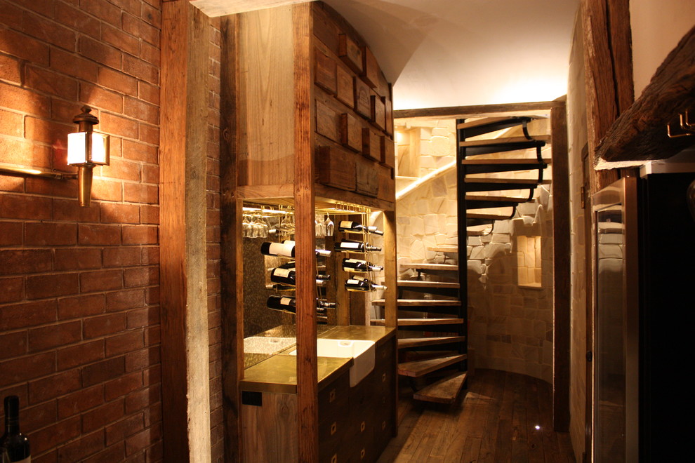 Photo of a large country wine cellar in Sydney with medium hardwood floors and display racks.