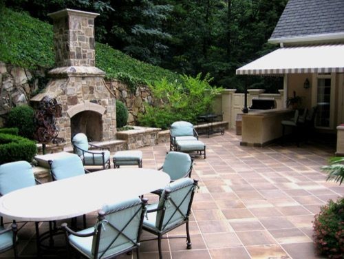 This is an example of a large mediterranean backyard pool in Atlanta with natural stone pavers.