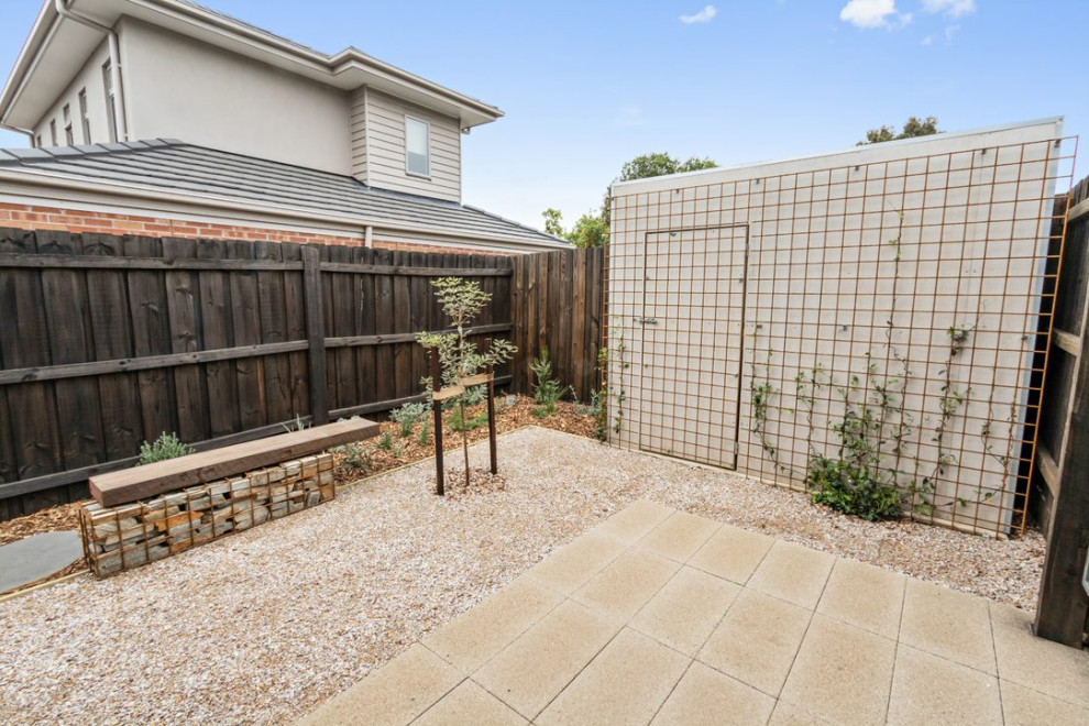 Photo of a small, desert look and australian native industrial backyard full sun xeriscape for spring in Melbourne with gravel.