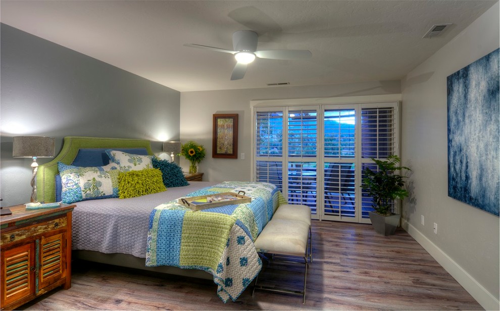 Photo of a small industrial master bedroom in Other with grey walls, cork floors and no fireplace.