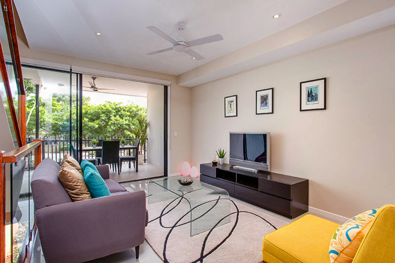 Small modern open concept living room in Brisbane with beige walls, porcelain floors, no fireplace, a freestanding tv and white floor.