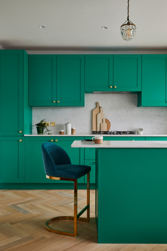 Design ideas for a kitchen in London with shaker cabinets, green cabinets, marble benchtops, with island and white benchtop.