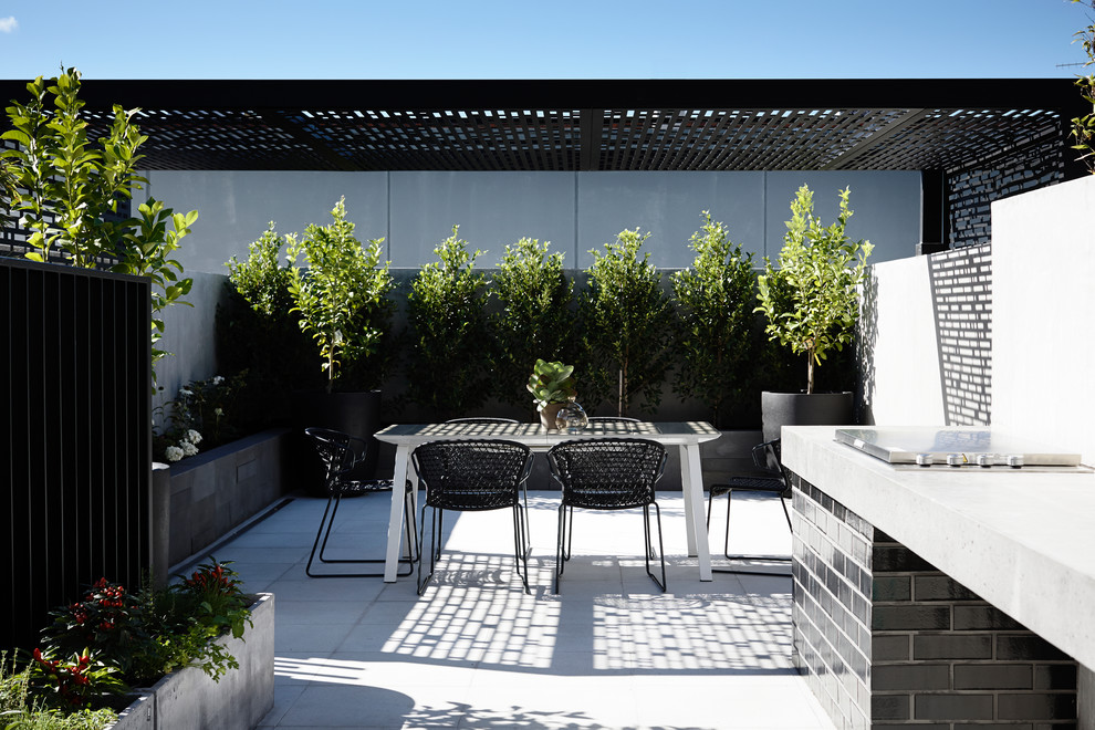 Mid-sized contemporary patio in Melbourne with an outdoor kitchen and a pergola.