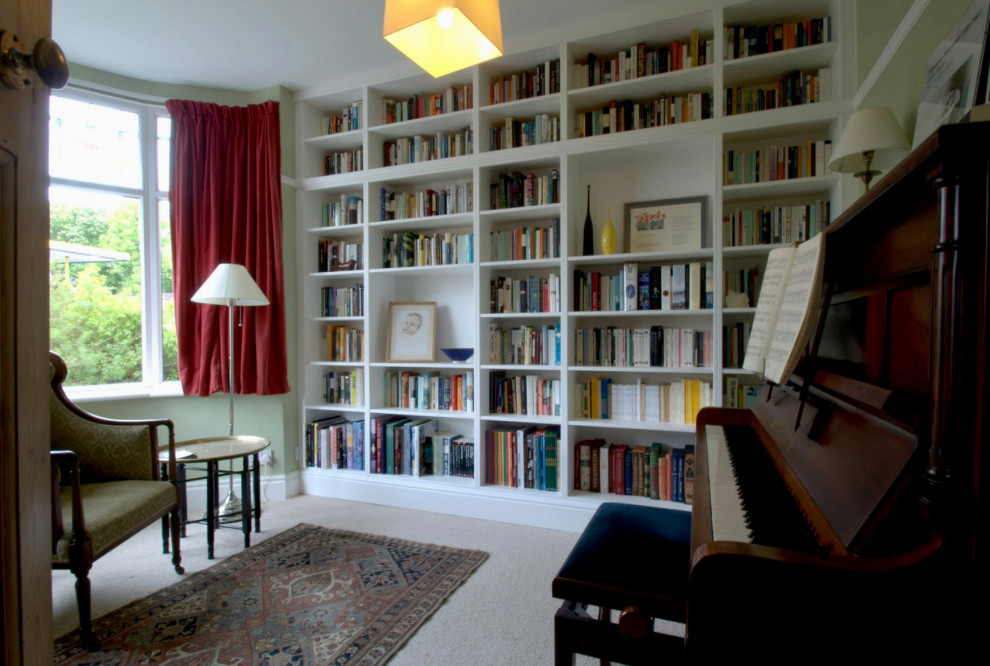 Photo of a mid-sized transitional enclosed living room in Other with a library and carpet.