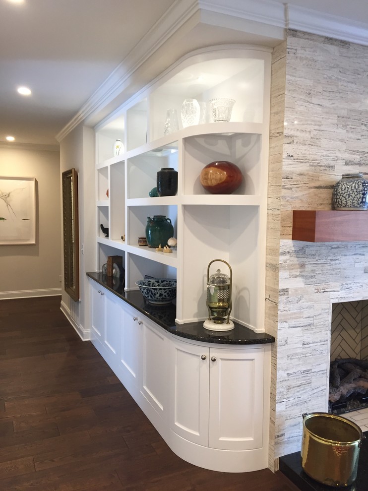 This is an example of a large transitional open concept living room in Jacksonville with beige walls, dark hardwood floors, a standard fireplace, a tile fireplace surround and a built-in media wall.
