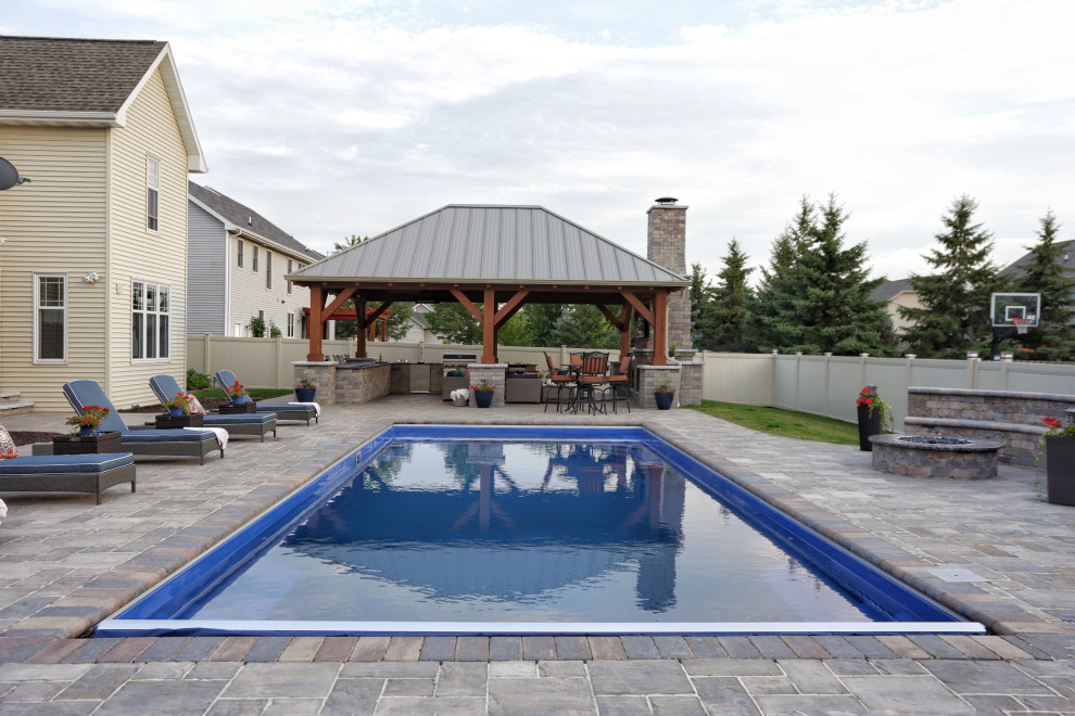 Pool - mid-sized rustic backyard stone privacy and full sun pool idea