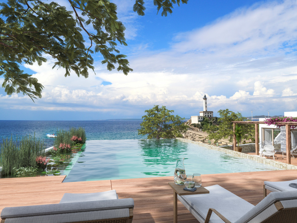 Imagen de piscina infinita mediterránea grande rectangular en patio lateral con paisajismo de piscina y adoquines de piedra natural