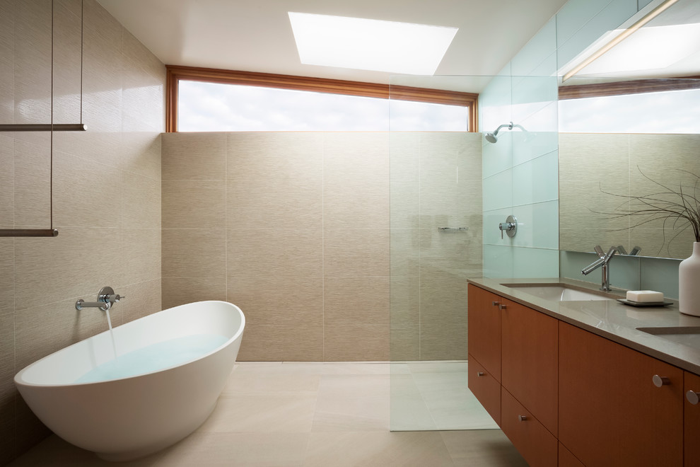 Inspiration for a mid-sized contemporary master bathroom in Portland with medium wood cabinets, a freestanding tub, a curbless shower, beige tile, an undermount sink, quartzite benchtops, flat-panel cabinets and an open shower.