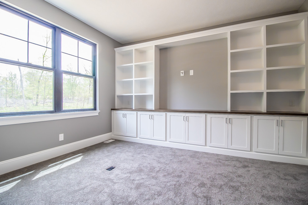 Photo of an expansive transitional study room in Cleveland with grey walls, carpet and grey floor.