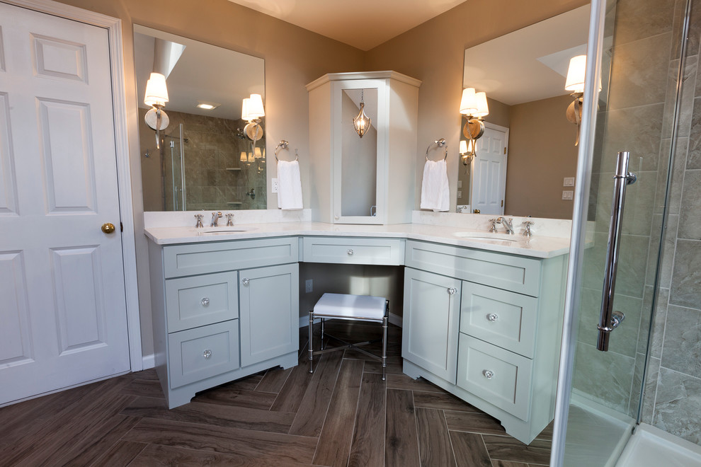 Freestanding bathtub - mid-sized transitional master gray tile and porcelain tile porcelain tile and gray floor freestanding bathtub idea in New York with flat-panel cabinets, gray cabinets, a two-piece toilet, gray walls, an undermount sink, quartz countertops and a hinged shower door