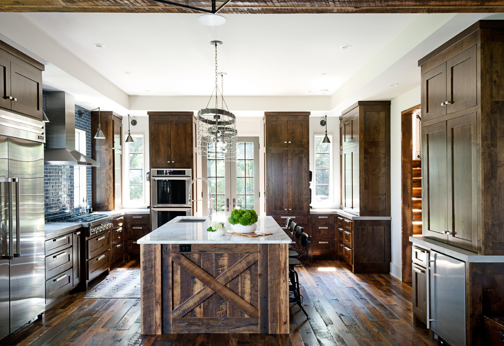Inspiration for a large rustic u-shaped dark wood floor kitchen remodel with an undermount sink, shaker cabinets, dark wood cabinets, blue backsplash, subway tile backsplash, stainless steel appliances and an island