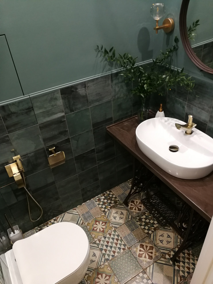 Example of a mid-sized urban blue tile and ceramic tile ceramic tile and blue floor powder room design in Moscow with a wall-mount toilet, blue walls, a drop-in sink, solid surface countertops and brown countertops