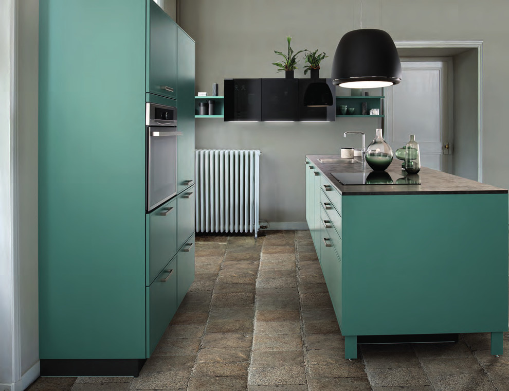 Small modern kitchen in London with a drop-in sink, green cabinets, laminate benchtops, cement tiles and beige floor.