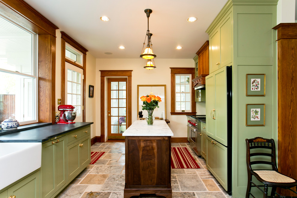 Inspiration for a traditional separate kitchen in DC Metro with a farmhouse sink, green cabinets, soapstone benchtops, limestone floors, with island, shaker cabinets, window splashback, panelled appliances and multi-coloured floor.