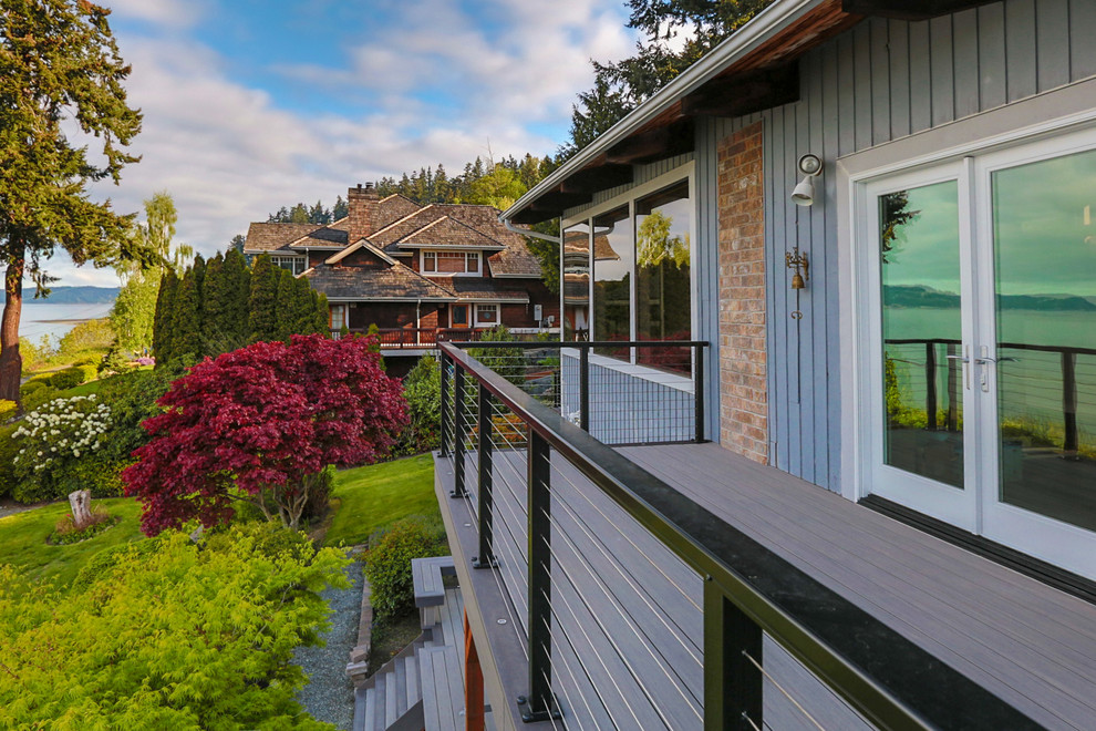 Large beach style side yard deck photo in Seattle