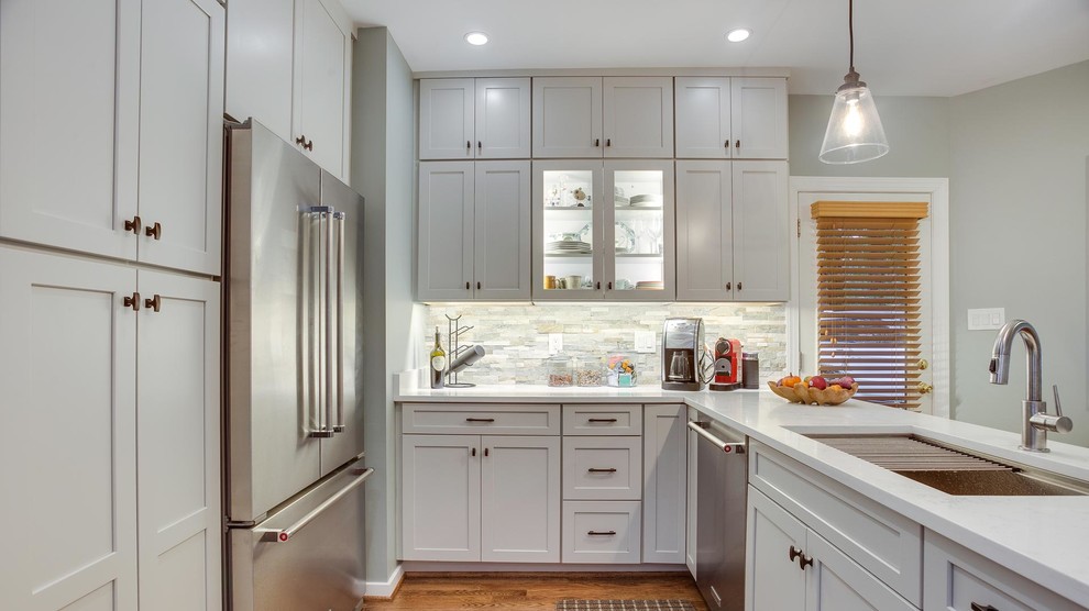 This is an example of a mid-sized transitional u-shaped eat-in kitchen in DC Metro with with island.