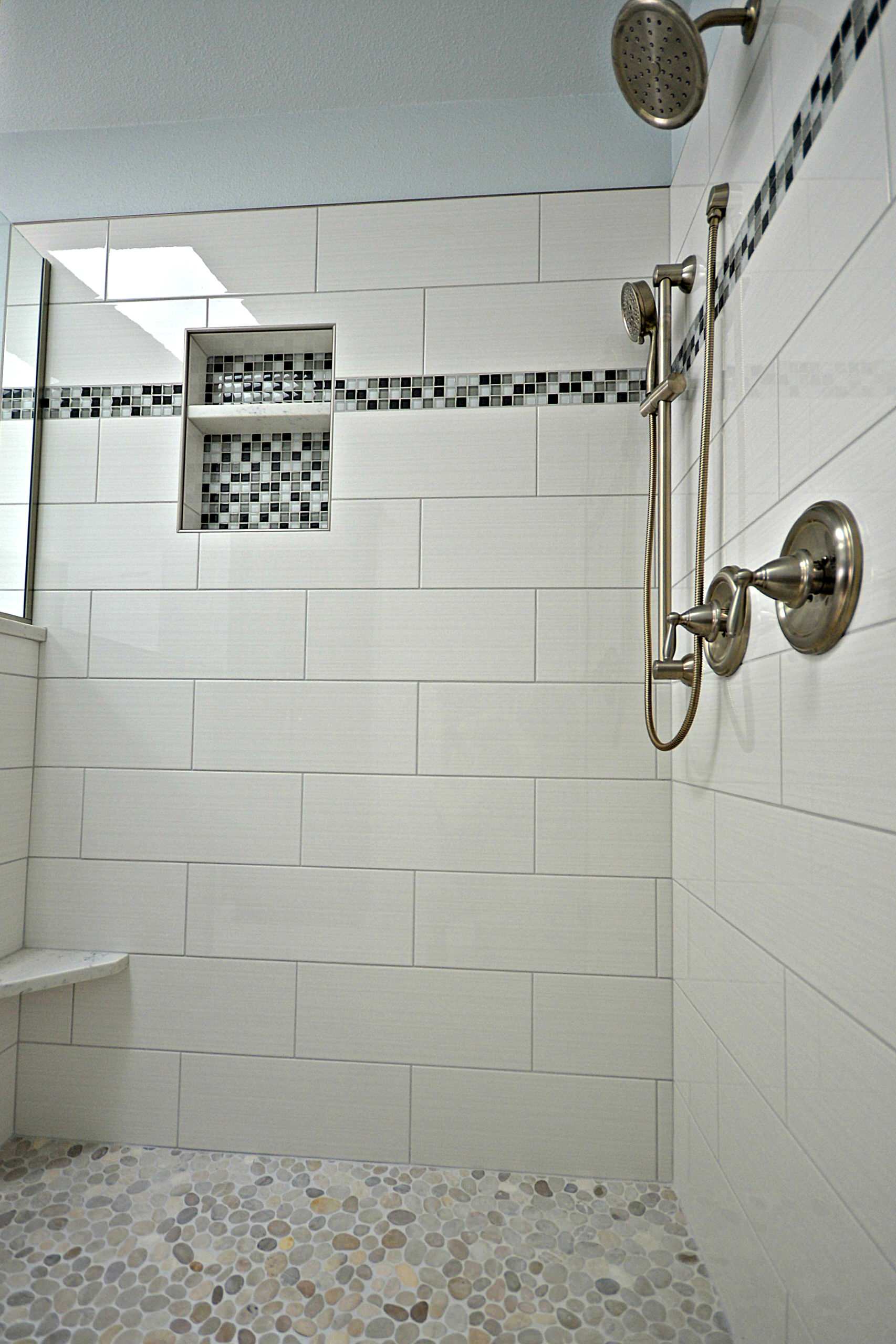 Updated tile with glass accents and glass tile niche.