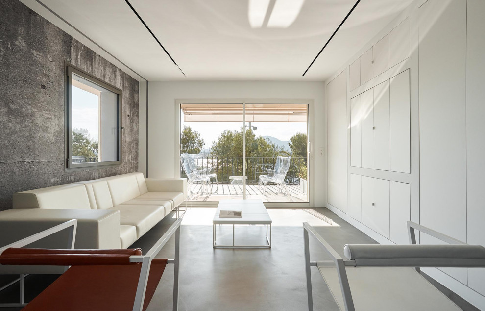 Cette photo montre un salon moderne ouvert avec un mur blanc, sol en béton ciré, un téléviseur encastré et un sol gris.