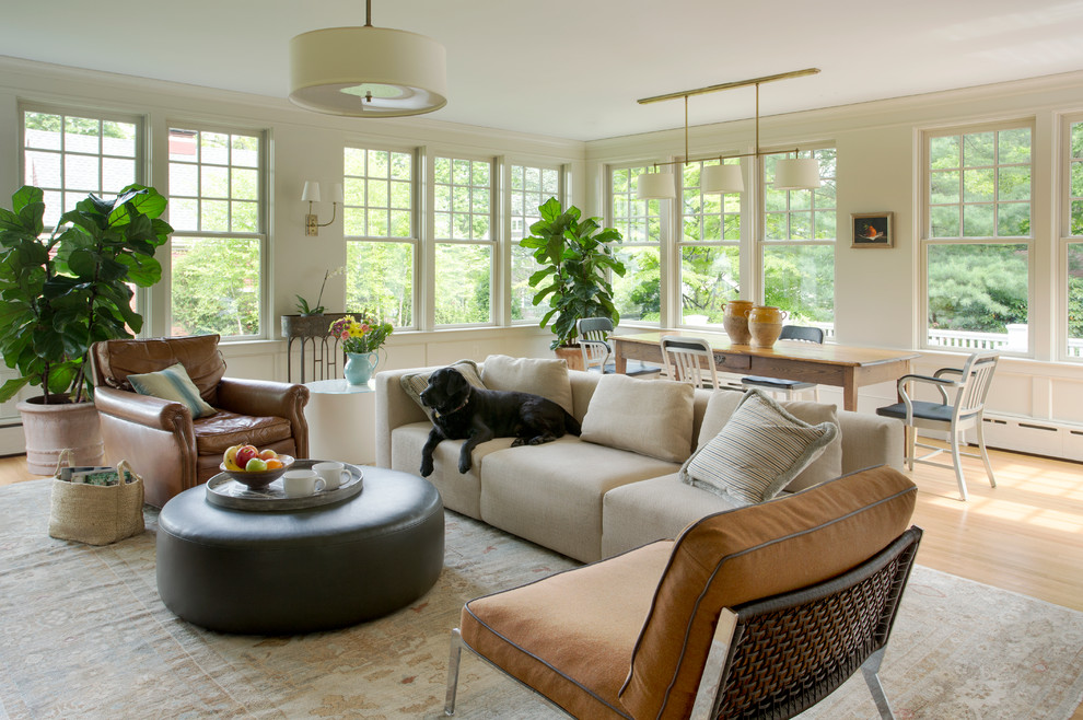 Photo of a mid-sized traditional open concept family room in Boston with beige walls, light hardwood floors and no tv.