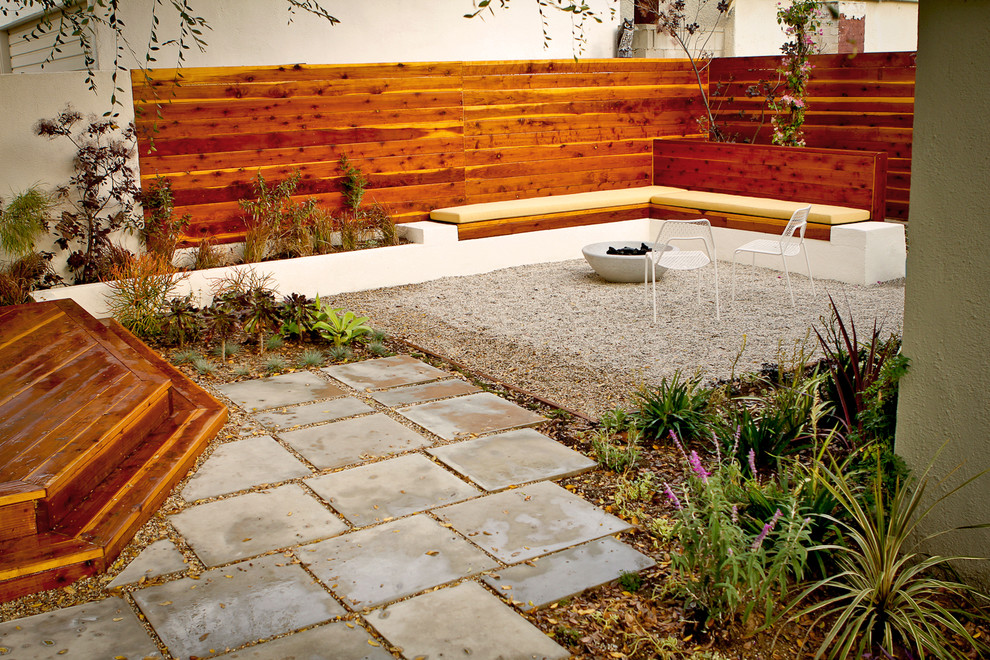 This is an example of a small contemporary backyard partial sun xeriscape in Los Angeles with concrete pavers.