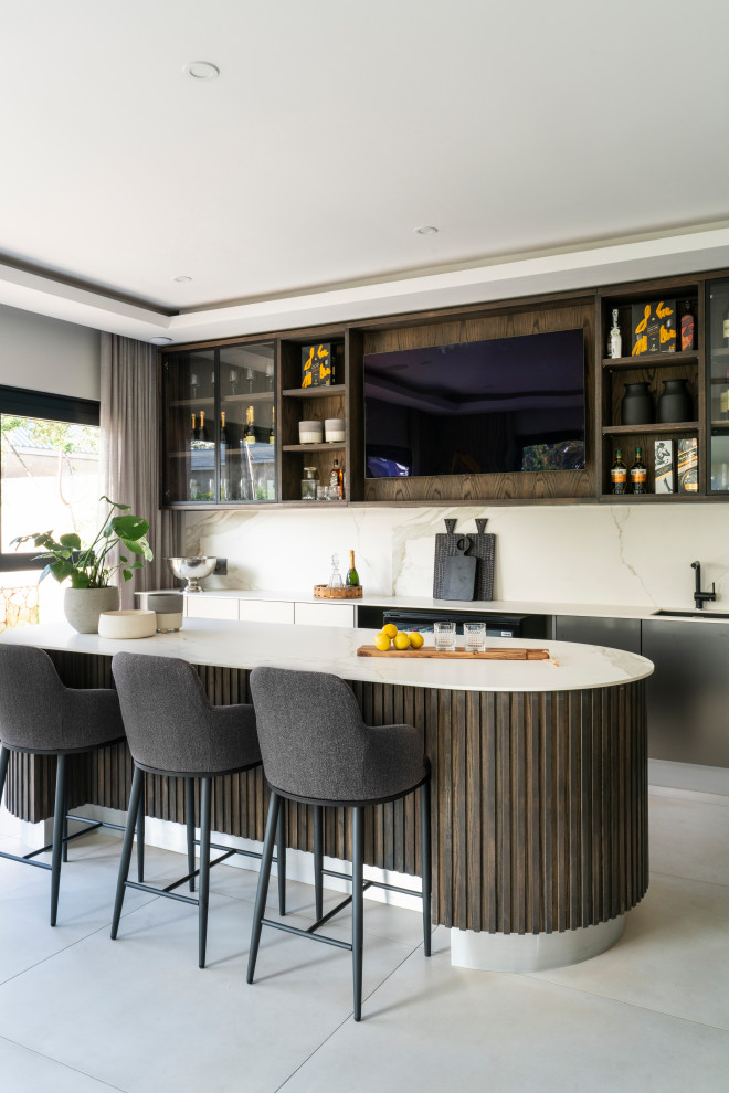 Design ideas for an expansive contemporary single-wall wet bar in Other with an integrated sink, beaded inset cabinets, dark wood cabinets, quartz benchtops, white splashback, stone slab splashback, porcelain floors, white floor and white benchtop.
