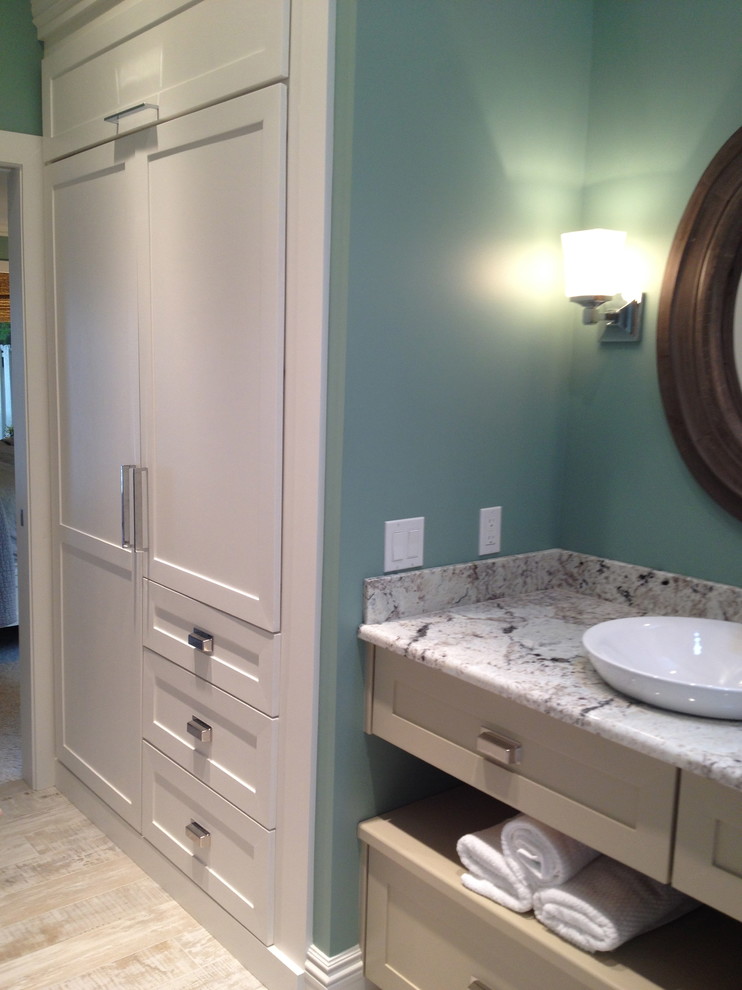 Small transitional master bathroom in Detroit with shaker cabinets, beige cabinets, a freestanding tub, a corner shower, gray tile, marble, green walls, vinyl floors, a vessel sink, quartzite benchtops, grey floor, a hinged shower door and grey benchtops.