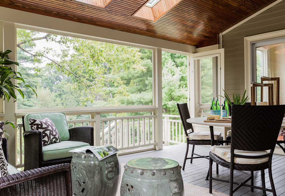 Example of a mid-sized classic backyard deck design in Boston with a roof extension
