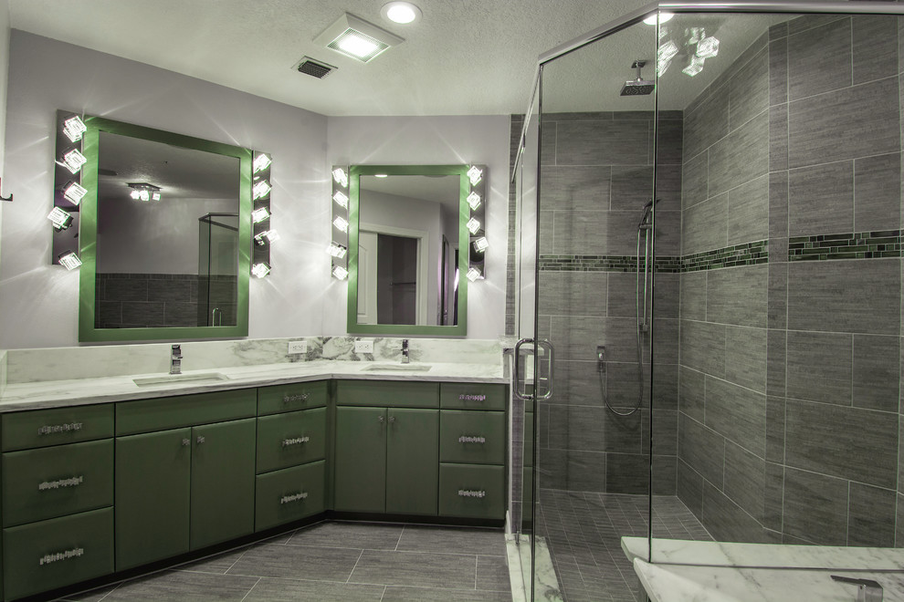 Large contemporary master bathroom in Tampa with a vessel sink, flat-panel cabinets, green cabinets, marble benchtops, a drop-in tub, an open shower, a one-piece toilet, gray tile, porcelain tile, grey walls and porcelain floors.