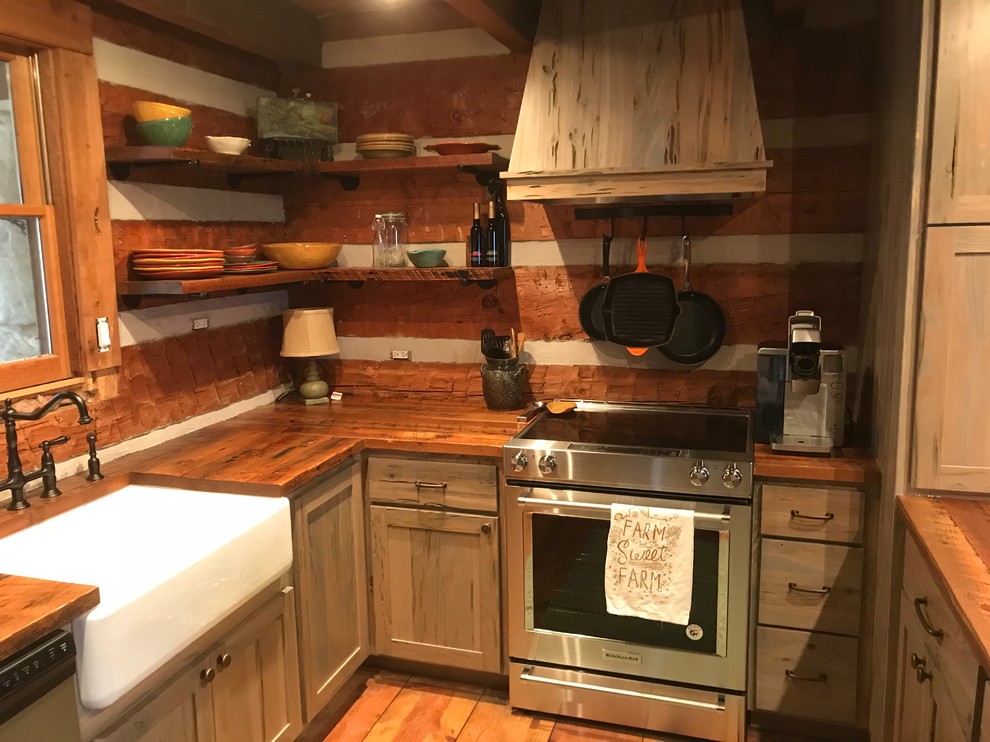Design ideas for a small country u-shaped eat-in kitchen in Atlanta with a farmhouse sink, shaker cabinets, distressed cabinets, wood benchtops, brown splashback, timber splashback, stainless steel appliances, light hardwood floors, with island, brown floor and brown benchtop.