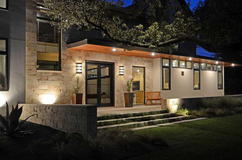 Photo of a large modern front yard verandah in Dallas with concrete slab and an awning.