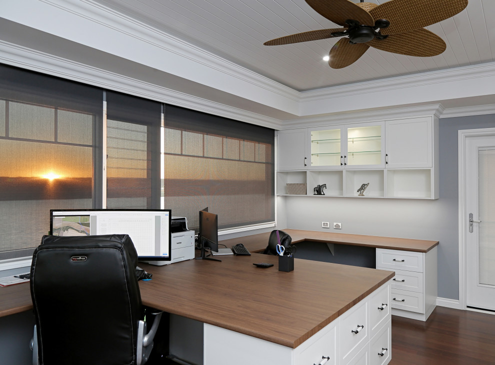 Design ideas for a large beach style study room in Sunshine Coast with blue walls, dark hardwood floors, a built-in desk, brown floor and coffered.