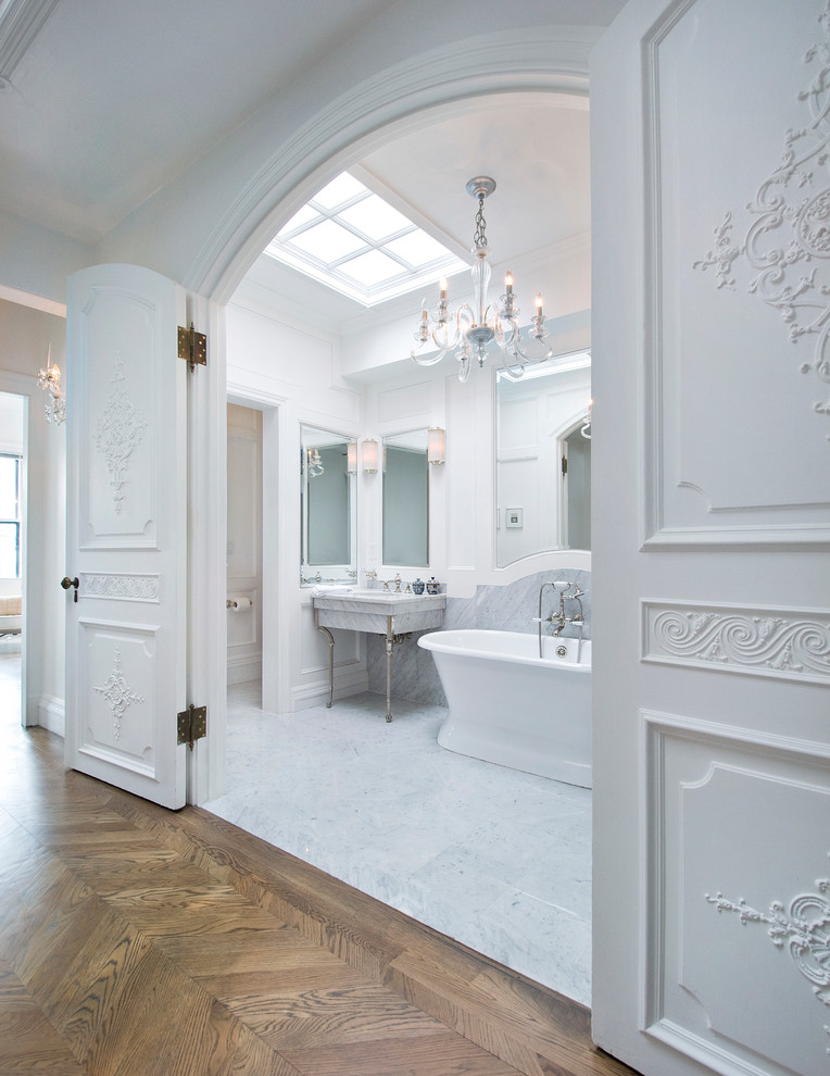 Design ideas for a traditional bathroom in Boston with a freestanding tub, white tile and white walls.