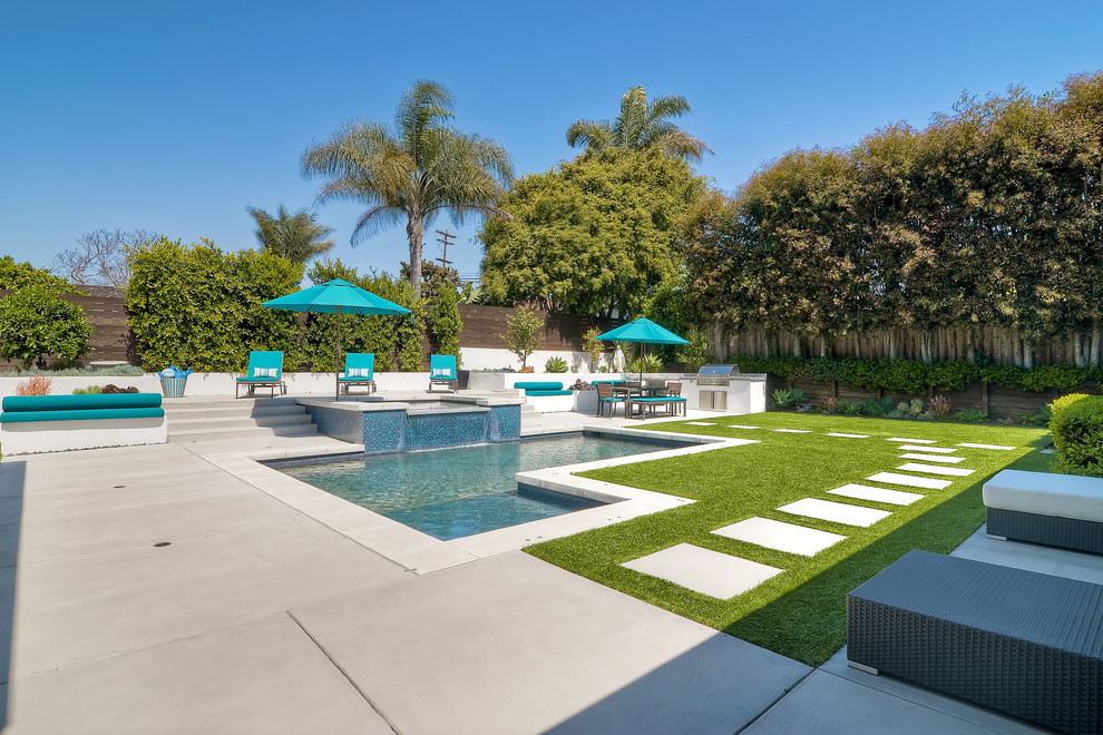 Contemporary backyard custom-shaped pool in San Diego with a hot tub and concrete slab.