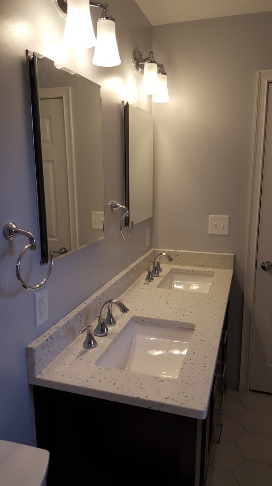 Alcove shower - small transitional 3/4 blue tile and glass tile porcelain tile alcove shower idea in Cincinnati with recessed-panel cabinets, black cabinets, a two-piece toilet, gray walls, an undermount sink and quartz countertops