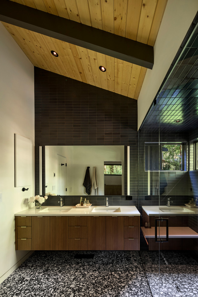 Midcentury master bathroom in Portland with medium wood cabinets, an open shower, a one-piece toilet, black tile, ceramic tile, terrazzo floors, a drop-in sink, engineered quartz benchtops, black floor, an open shower, white benchtops, a double vanity, a floating vanity and exposed beam.