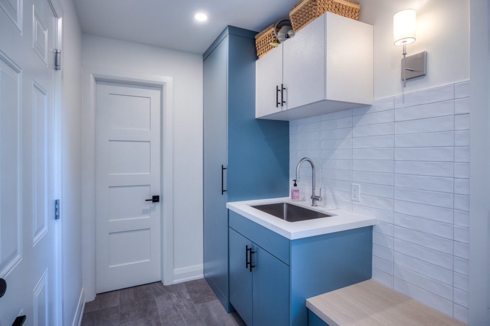 This is an example of a mid-sized contemporary entryway in Toronto with blue walls, ceramic floors, a single front door, a white front door and grey floor.