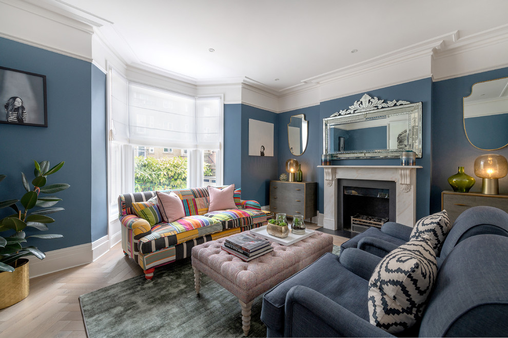 Inspiration for a traditional living room in London with blue walls.