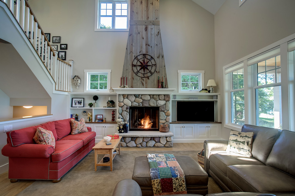 Mid-sized country loft-style living room in Other with a library, beige walls, linoleum floors, a standard fireplace, a stone fireplace surround and a wall-mounted tv.